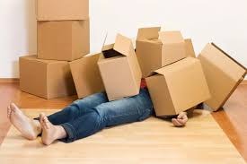 Person surrounded by cardboard moving boxes